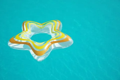 Star shaped inflatable ring floating in swimming pool on sunny day. Space for 스톡 사진