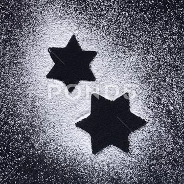 Star Shapes In Icing Sugar On Black Background
