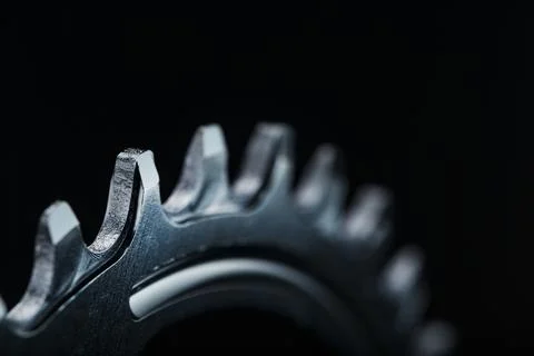 Star teeth pattern with bicycle chain mechanisms on black background. Stock Photos