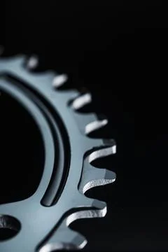 Star teeth pattern with bicycle chain mechanisms on black background. Foto stock