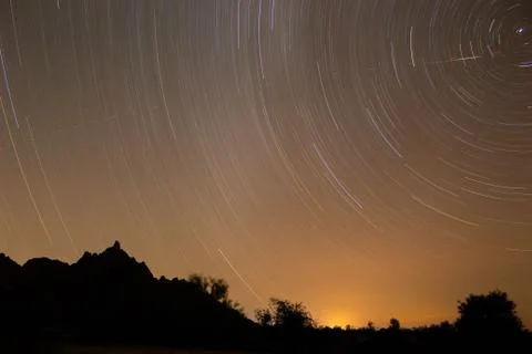 Star timelapse over an empty desert landscape Stock Photos