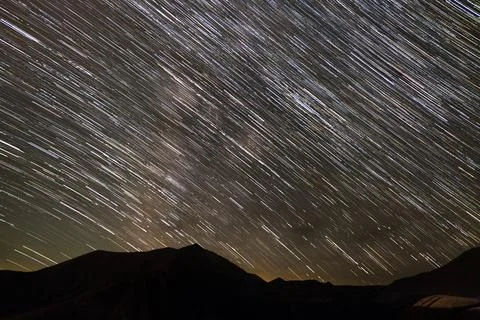 Star tracks  over mountain range. Stock Photos