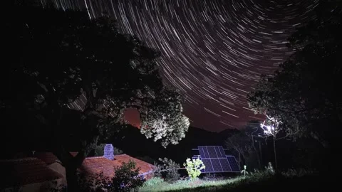 Star trail long-exposure time lapse over ecological farm, solarpunk Stock Footage 231121152