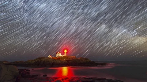 Star trails moving behind Nubble Lighthouse Stock Footage 75928646