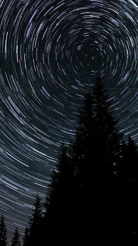 Star trails in the night sky Stock Footage 262140424