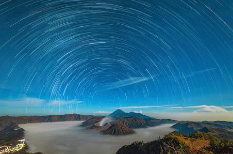 Star trails over the volcano. Clouds. Night Stock Photos