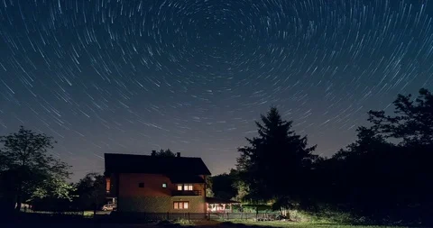 Star trails time lapse above the house. Residential building and the star trails Stock Footage 86295500