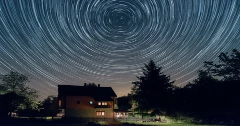 Star trails time lapse above the house. Residential building and the star trails Stock Footage 86296144