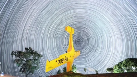 Star trails time-lapse of night sky with yellow plane Stock-Footage 299779664