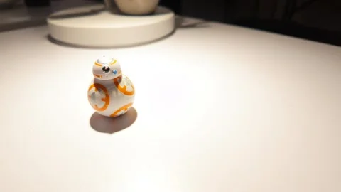 Star Wars R2D2 miniature figure under lamp lighted desk - 4K Video stock 306018448