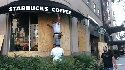 Starbucks boards up windows in preperation for BLM protest march. Stock Footage 140029375