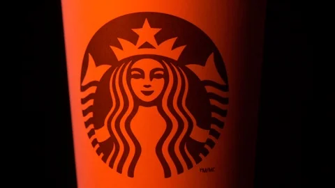 Starbucks coffee cup rotating in styled Christmas red light medium CU shot 4k Stock Footage 108189909