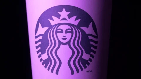Starbucks coffee cup rotating in styled purple light medium CU shot 4k Stock Footage 108190520