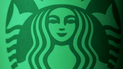 Starbucks coffee cup rotating in styled Christmas green light ECU shot 4k Video stock 108190647