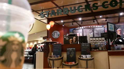 Starbucks Coffee Shop Interior and Branding with Blurred Cup Stock-Footage 345723345