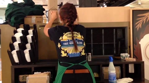 Starbucks worker cleaning workshop table Stock Footage 51686546