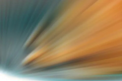 Starburst with light rays in orange and blue Illustrazione stock