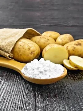 Starch potato in spoon on table Stock Photos
