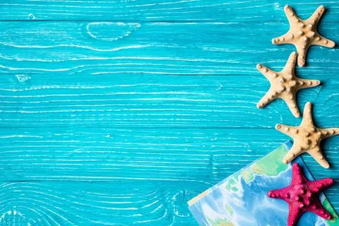 Starfish and map located on blue wooden background Stock Photos