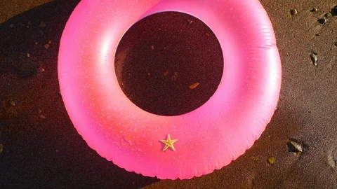 Starfish on the pink inflatable circle Stock Footage 97907761