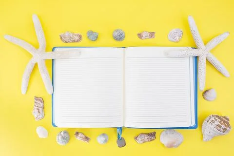 Starfish, shells around open lined notepad Stock Photos