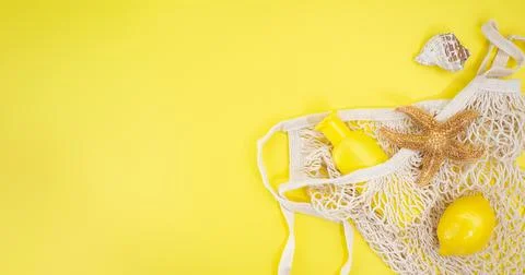 Starfish, shells with bag string with sunscreen bottle mockup and lemon Stock Photos