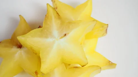Starfruit or star apple rotates on a white background Video stock 168363559