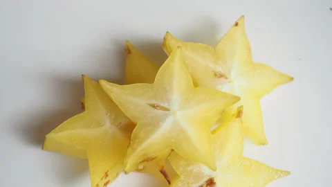 Starfruit or star apple rotates on a white background Stock Footage 196899290