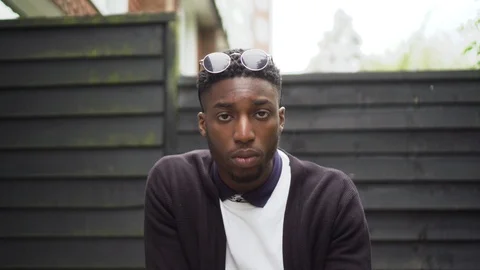 Staring at Camera and puts glasses down young man hustle Stock Footage 89922466