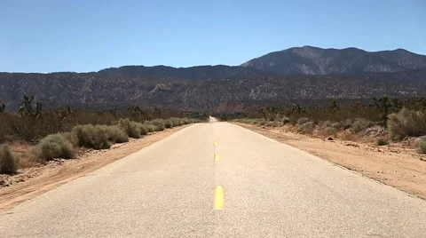 Staring Down a Stretch of Desert Highway Stock Footage 62579315