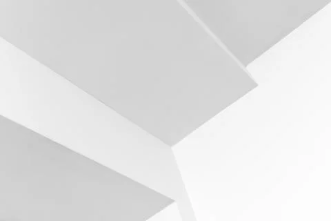 A stark, abstract composition of interlocking white planes and clean lines Stock Photos