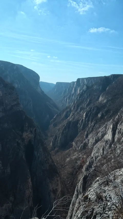 Stark cliffs loom over deep, sunlit canyon. Balkan, Eastern Europe, POV Stock Footage 333634739