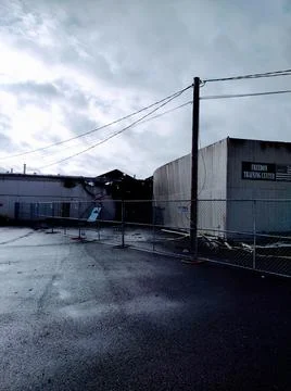 Stark empty burned out building showing fire damage on a desolate day Stock Photos