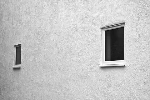 Stark external wall with plain windows Stock Photos