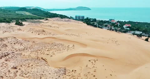 Stark geographical contrast between sand and water near Mui Ne, Vietnam Stock Footage 296720964