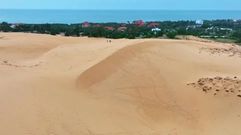 Stark geographical contrast between sand and water near Mui Ne, Vietnam Stock Footage 296720978