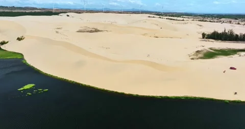 Stark geographical contrast between sand and water near Mui Ne, Vietnam Stock Footage 296721374