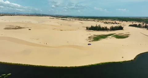 Stark geographical contrast between sand and water near Mui Ne, Vietnam Stock Footage 296721898