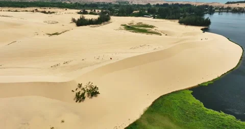 Stark geographical contrast between sand and water near Mui Ne, Vietnam Stock Footage 296721899