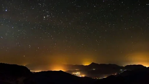 Starry night in mountains time lapse. Stars move over countryside. Night to day Stock Footage 69147760