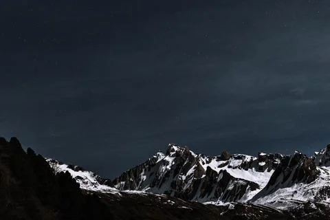 Starry night over a white summit Stock Photos