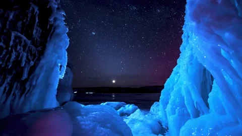 Starry Night Sky Above Glowing Blue Frozen Ice Cave Formations Stock-Footage 341213104
