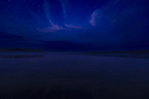 Starry night sky with clouds over a calm lake Stock Photos