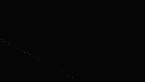 A starry night sky over a dark silhouette of mountains Vídeos de archivo 335255881