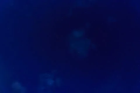 Starry night sky with scattered clouds Stock Photos