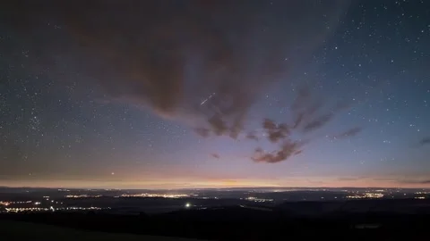 Starry night sky with stars time lapse motion over countryside traffic astronomy Stock Footage 147030890