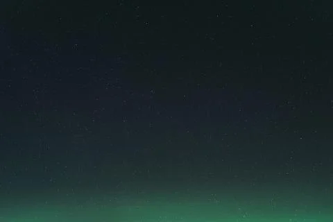 Starry Night Sky with Subtle Aurora Glow Background Stock Photos