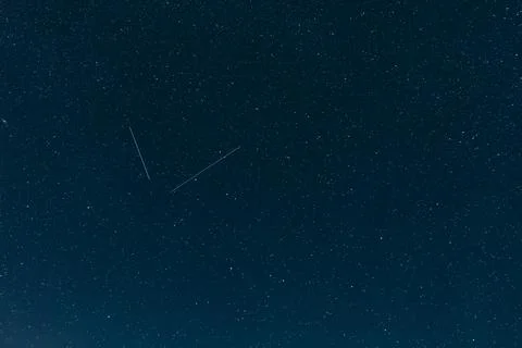 Starry night sky texture, dark deep blue cosmic backdrop, celestial field Stock Photos