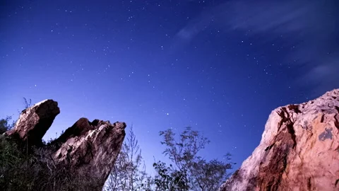 Starry night sky time lapse rocky mountain cold night moonlight stars shooting Stock Footage 131907249