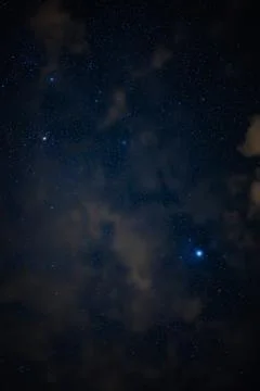 Starry Night Sky with Wispy Clouds and Bright Stars Stock Photos